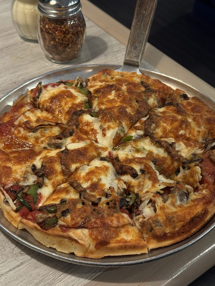 Loaded Athens pizza with peppers, mushrooms and melted cheese