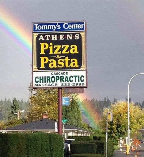 Athens Pizza and Pasta roadside sign with rainbow over Tommy's Center